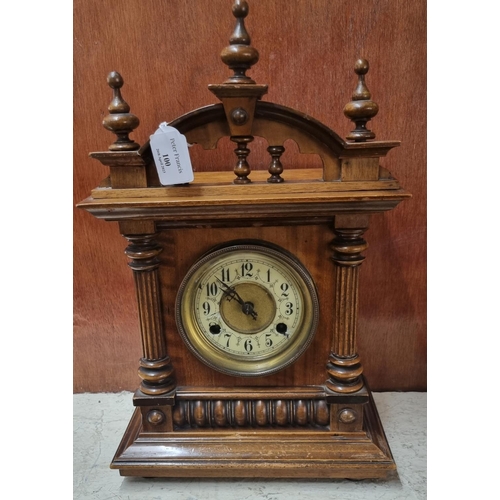 100 - Early 20th Century walnut probably German architectural two train mantel clock. 
(B.P. 21% + VAT)