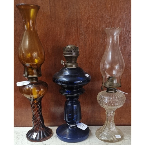 101 - Three early 20th Century single oil burner lamps, varying glass colours. (3)
(B.P. 21% + VAT)