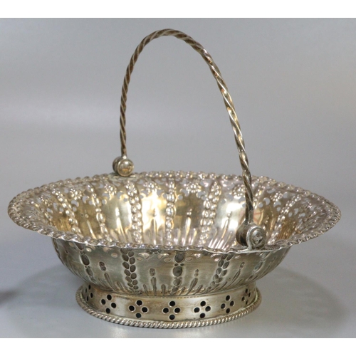 221 - Silver pierced basket/bonbon dish with spiral design swing handle, indistinct but probably London ha... 