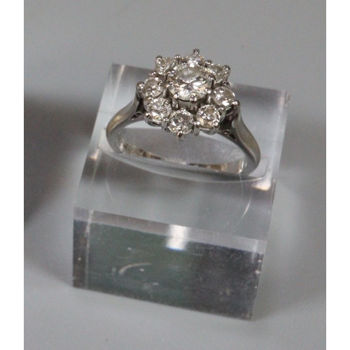 236 - Diamond cluster ring set in 18ct white gold.  The central brilliant cut diamond an estimated 0.52cts...