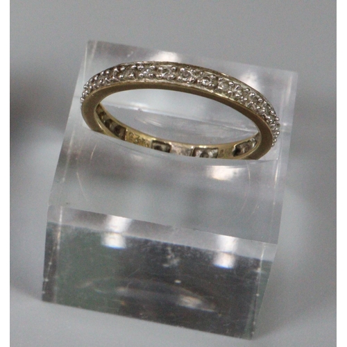 242 - 9ct gold diamond eternity ring, 2.1g approx.  Ring size O+1/2.  (B.P. 21% + VAT)