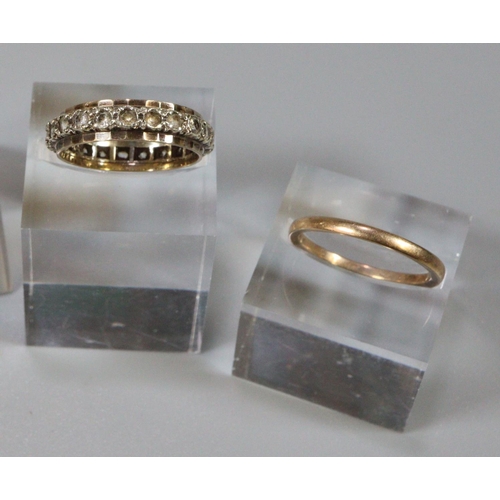 243 - Two 9ct gold rings; one eternity ring set with white stones and a plain gold band, both ring size N.... 