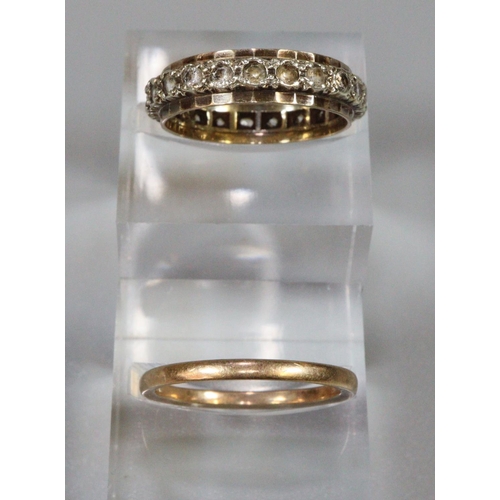 243 - Two 9ct gold rings; one eternity ring set with white stones and a plain gold band, both ring size N.... 