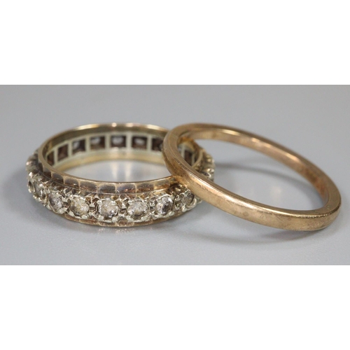 243 - Two 9ct gold rings; one eternity ring set with white stones and a plain gold band, both ring size N.... 