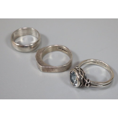 247 - Three assorted silver rings, one set with blue stone. (3)  (B.P. 21% + VAT)