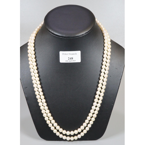 248 - A double row cultured pearl necklace with 9ct gold pearl set clasp.  Length 25 inches.
(B.P. 21% + V... 