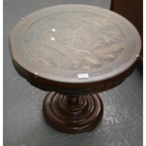 500 - Modern Oriental design hardwood drum table with glass top and carved decoration of figures, pagodas ... 