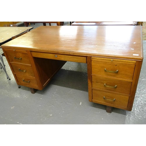 503 - 20th century design teak knee hole desk, the moulded top above central drawer flanked by three drawe... 