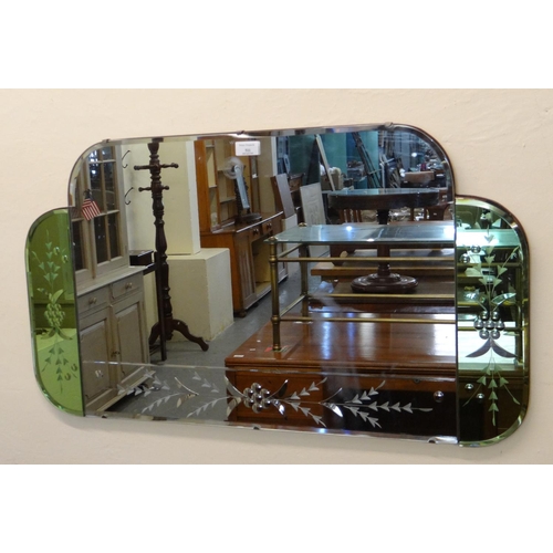 511 - Art Deco design cloud back frameless mirror having green panels with foliate decoration.  86x48cm ap... 