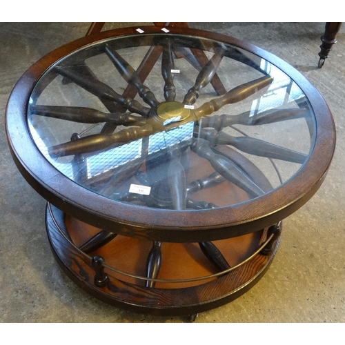 541 - Modern novelty oak revolving coffee/drinks table with glass top in the form of a ships wheel.  (B.P.... 