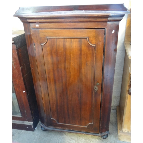 543 - 19th century mahogany blind panelled corner cupboard, now on bun feet with low gallery back, shaped ... 