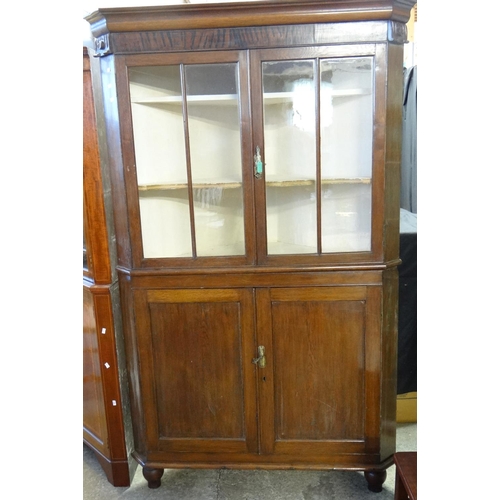 550 - 19th century Welsh oak glazed double corner cupboard with shaped shelves to the interior and two bli... 