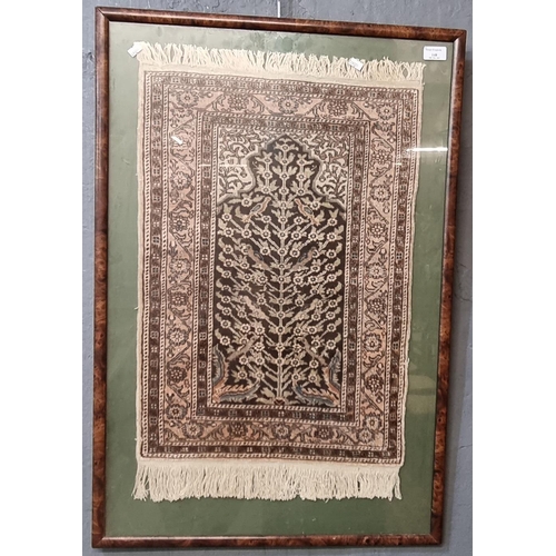 148 - Middle Eastern unidirectional prayer mat of 'Tree of Life' foliate design.  Framed and glazed.  The ... 