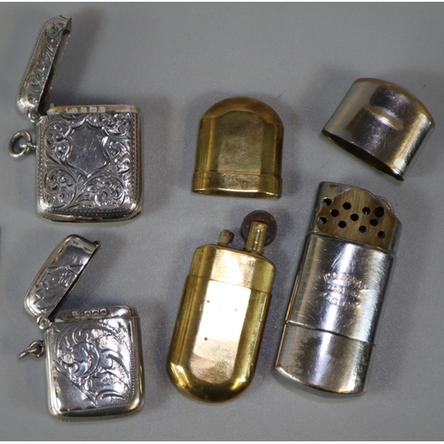 218 - Two similar silver vesta cases together with two vintage lighters.   (B.P. 21% + VAT)