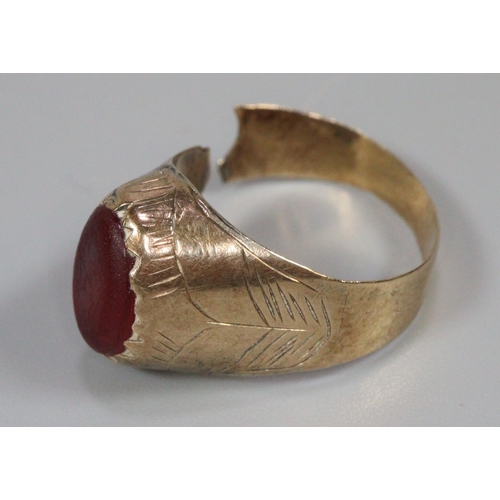 241 - Yellow metal ring with a red stone (cut), 3.5g approx.  (B.P. 21% + VAT)