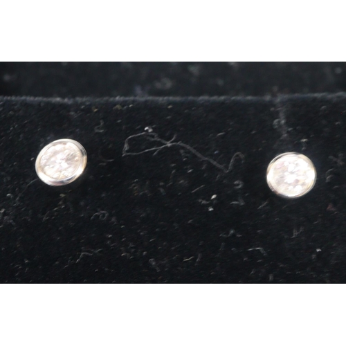 245 - 9ct gold diamond pair of stud earrings.  1g approx.  (B.P. 21% + VAT)