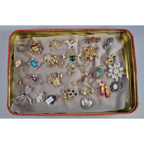 286 - Tin box of assorted costume brooches to include: horse and jockey, dragonfly, cat, flowers etc. 
(B.... 