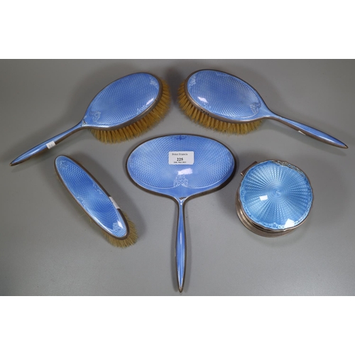 225 - A silver and guilloche enamelled dressing table set comprising: three brushes, hand mirror and a tri... 