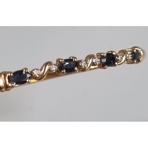 235 - 9ct gold blue and white stone bangle. 4.3g   (B.P. 21% + VAT)