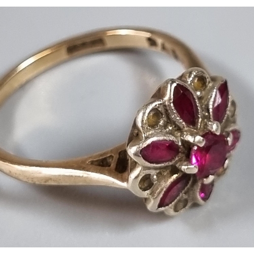 256 - 9ct gold purple stone flower head ring.  3g approx.  Ring size M 1/2.  (B.P. 21% + VAT)