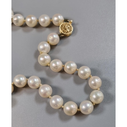 269 - String of well matched cultured pearls with pierced gilt metal filigree clasp.   (B.P. 21% + VAT)