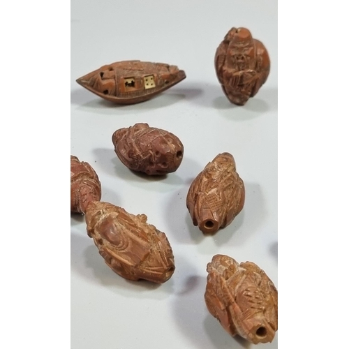 304 - Nine Chinese carved wood beads comprising two Buddha figures, six immortals and a small boat.  Each ... 