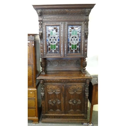 489 - Late Victorian oak ornately carved Flemish design stained glass and leaded glazed two door cabinet. ... 