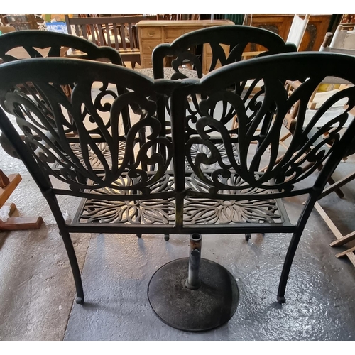 502 - Cast metal garden set comprising two elbow chairs, garden seat and circular table.   (B.P. 21% + VAT... 