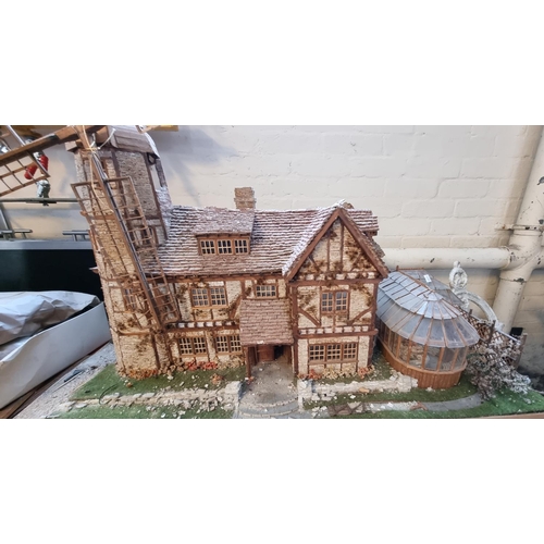 523 - Two unusual vintage doll's houses in the form of a shop and large timbered house with conservatory a... 