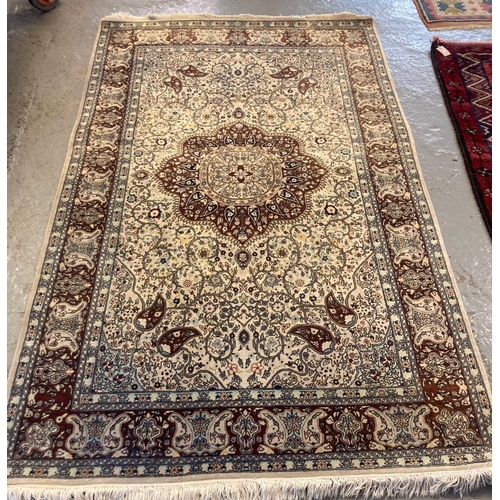 545 - 20th century Persian design carpet on a cream ground with central flowerhead medallion surrounded by... 