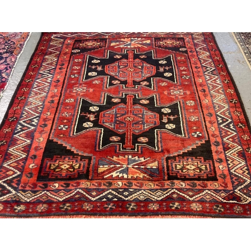 552 - 20th century Middle Eastern design red ground carpet with central medallion design, stylised birds a... 