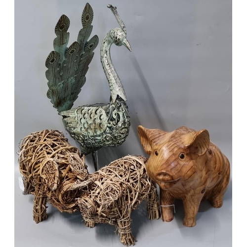 101 - Two wicker models of pigs together with another carved wooden seated pig with glass eyes and a metal... 