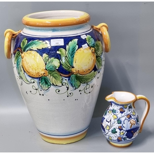 102 - Large Italian pottery classical design vase decorated with lemons and foliage together with another ... 