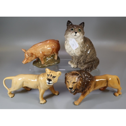 184 - Four ceramic animal figures; A Beswick lioness and male lion, a Quail pig money box and a Beswick 18... 