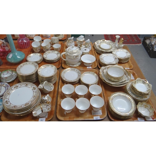 385 - Six trays of Noritake porcelain Japanese tea and dinnerware items on a white ground with gilded bouq... 