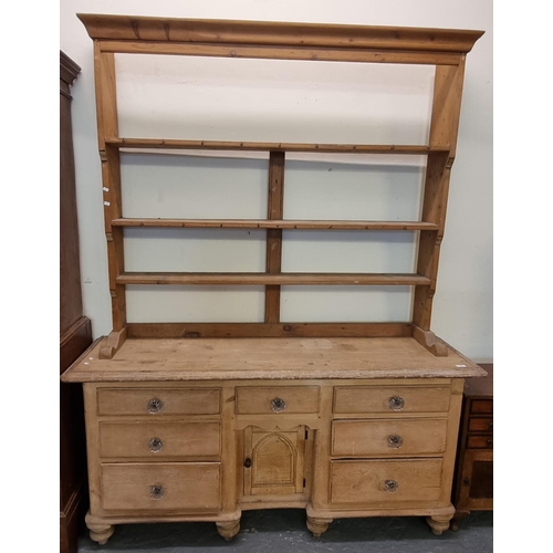 549 - 19th century pine rack back dresser, the open rack above a moulded top with an arrangement of seven ... 