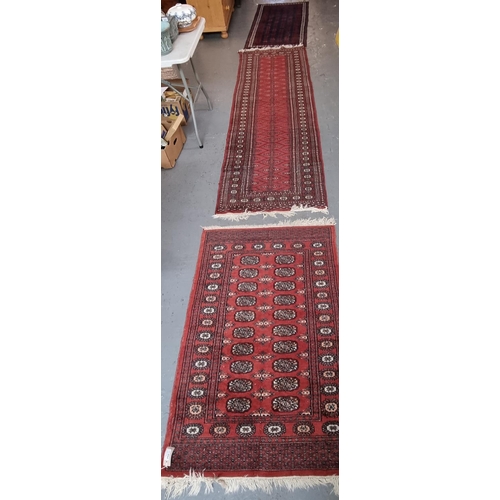 590 - Three Middle Eastern red ground geometric, floral and foliate red ground runners.  (3)  (B.P. 21% + ... 