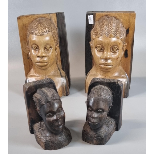 69 - Two pairs of African carved hardwood figural bookends.  18.5 cm and 10.5cm high approx.  (4)   (B.P.... 