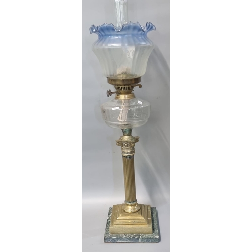 87 - Early 20th century double oil burner lamp having blue frilled and frosted etched glass shade above c... 