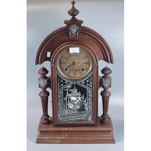 91 - Early 20th century walnut architectural mantle clock with mask head mounts, pendulum and two keys.  ... 