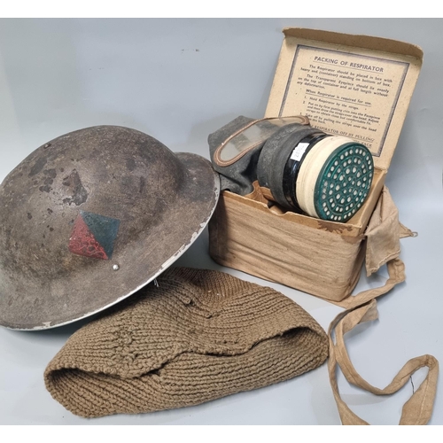 96 - WWII helmet dated 1938/9? together with a boxed gas mask.  (2)   (B.P. 21% + VAT)