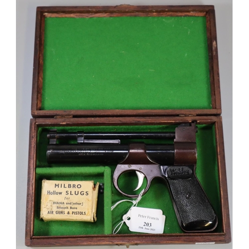 203 - The Webley Junior .177 air pistol with blued action and black grips marked 'Webley' in fitted mahoga... 