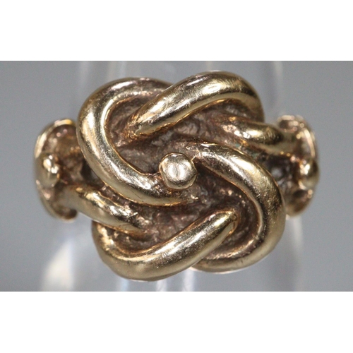 280 - Yellow metal knot design ring.  Size K1/2.  6.5g approx.  (B.P. 21% + VAT)