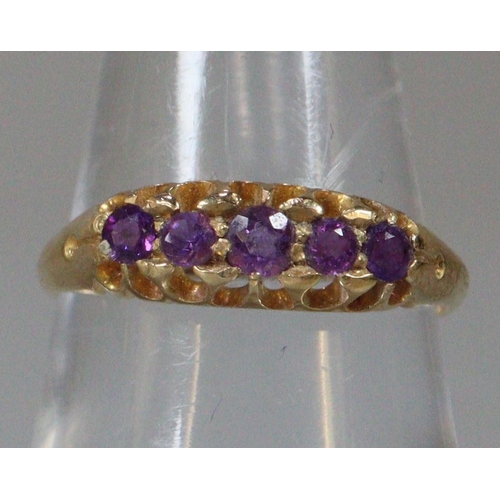 291 - 18ct gold purple five stone dress ring.  Size M1/2.  2.9g approx.  (B.P. 21% + VAT)