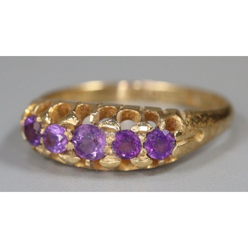 291 - 18ct gold purple five stone dress ring.  Size M1/2.  2.9g approx.  (B.P. 21% + VAT)