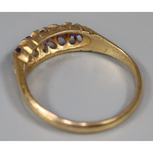 291 - 18ct gold purple five stone dress ring.  Size M1/2.  2.9g approx.  (B.P. 21% + VAT)