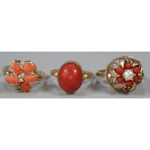 292 - Two 9ct gold and coral dress rings together with another yellow metal dress ring.  10g approx.  (3) ... 