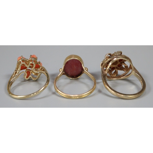 292 - Two 9ct gold and coral dress rings together with another yellow metal dress ring.  10g approx.  (3) ... 