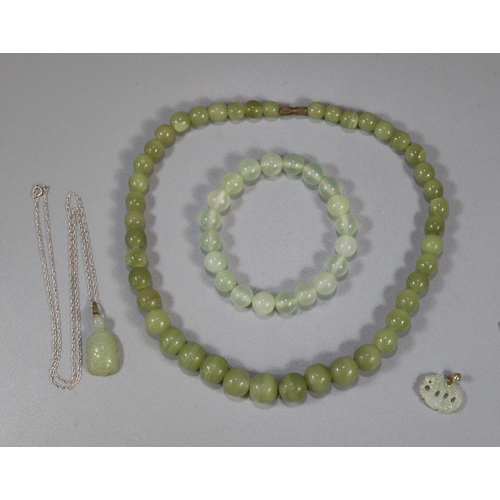 309 - Green hardstone beaded necklace with similar bangle and Chinese green hardstone pendant on chain in ... 