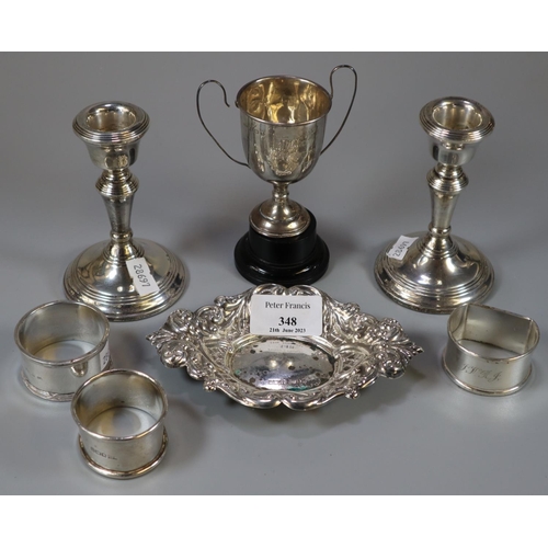 348 - Bag of silver to include: three napkin rings, small two handled trophy cup, silver bonbon dish/pin t... 